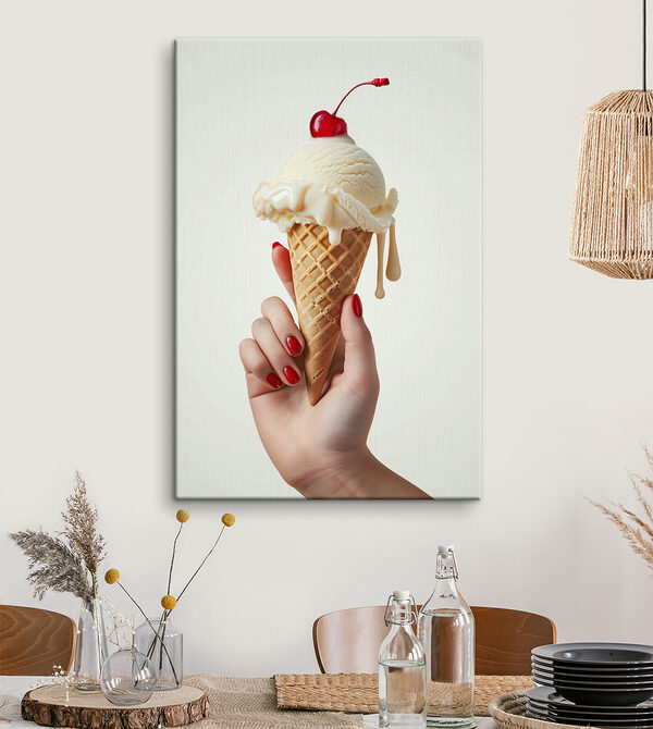 Hand holding an ice cream cone with a cherry on top