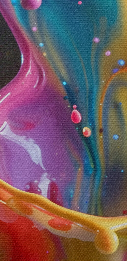 Colorful splashing liquid in a cup Colorful splashing liquid in a cup