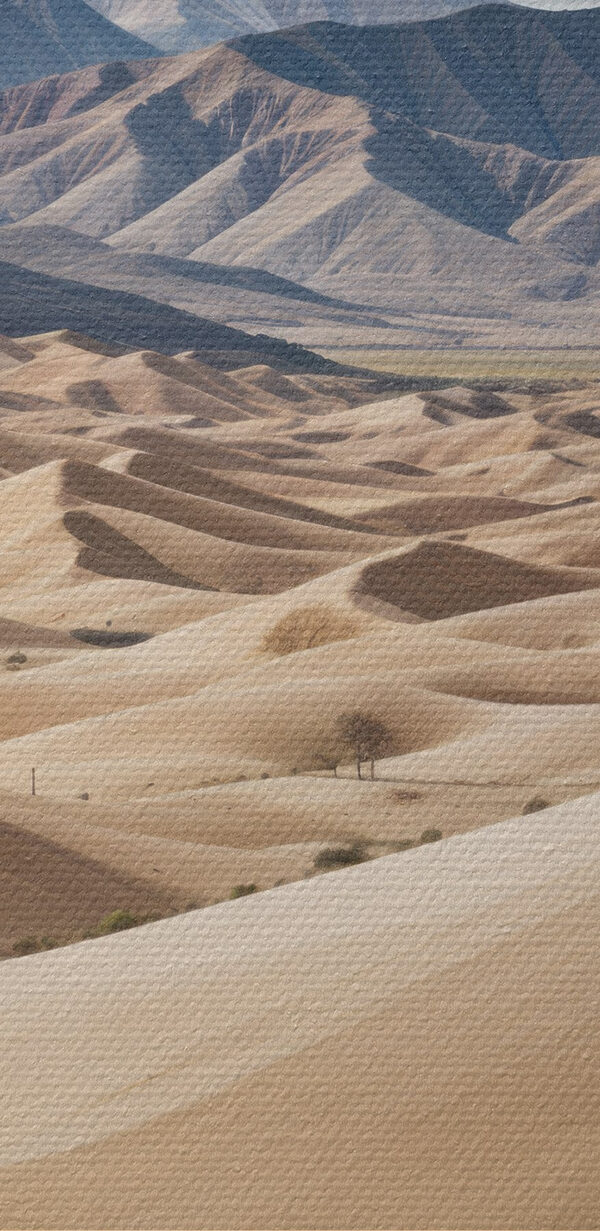 Large sandy hills with mountains in the background Large sandy hills with mountains in the background