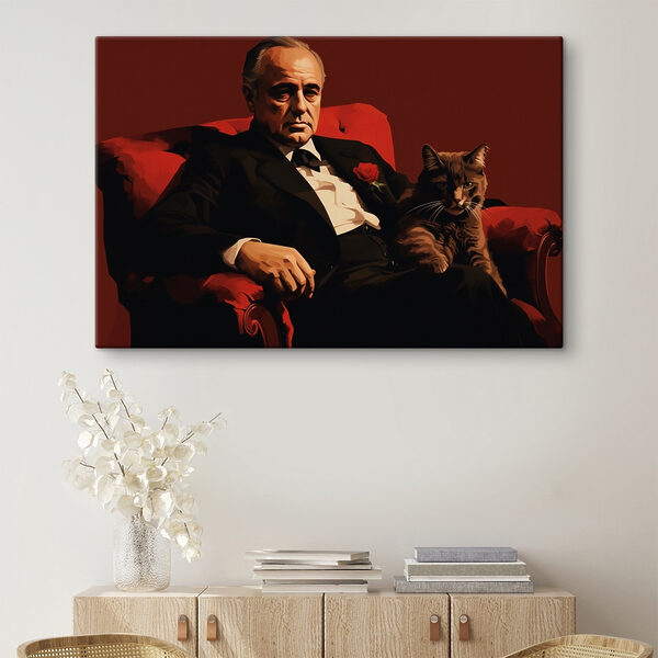 Man in a suit and tie sitting in a chair with a cat