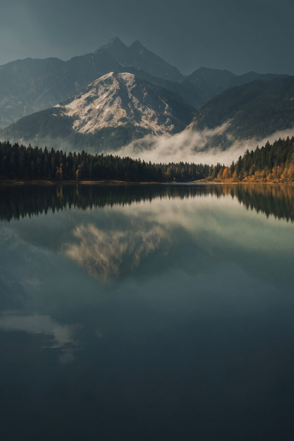 Lake with trees and mountains in the background Lake with trees and mountains in the background