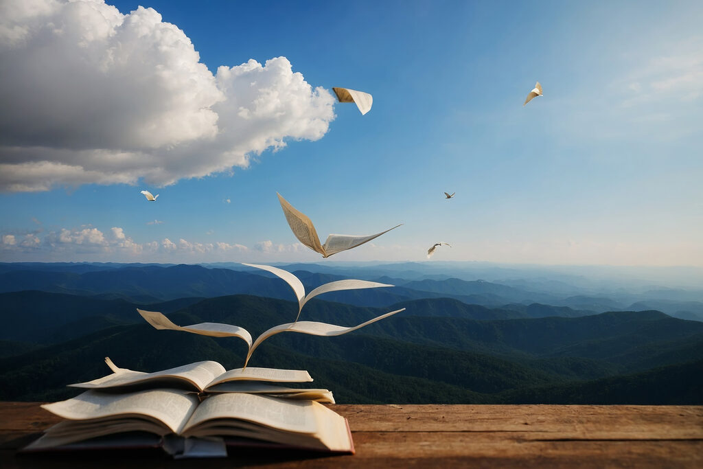 Book with flying birds flying out of it