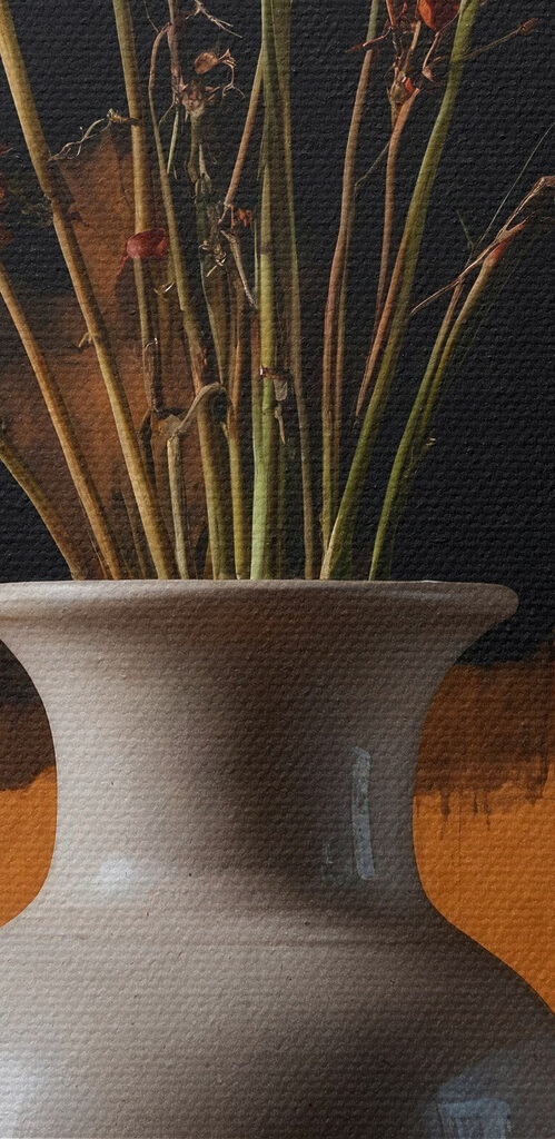 Vase with dried flowers and oranges