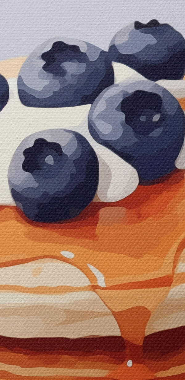 Stack of pancakes with blueberries and syrup on top
