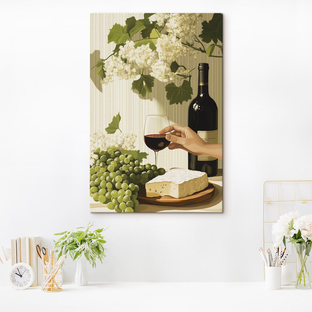 Hand holding a glass of wine next to a bottle of wine
