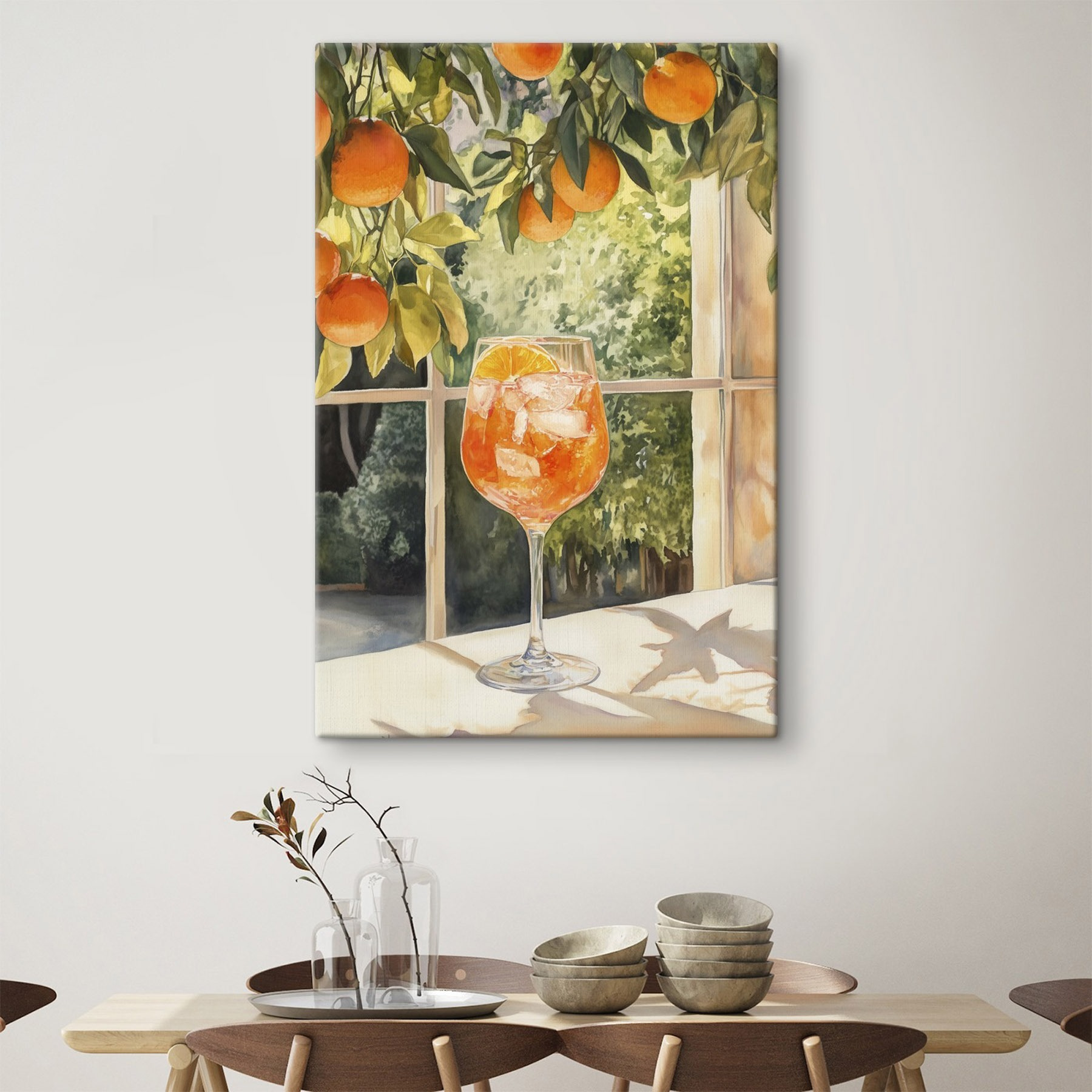 Glass of orange juice with ice and oranges from a window