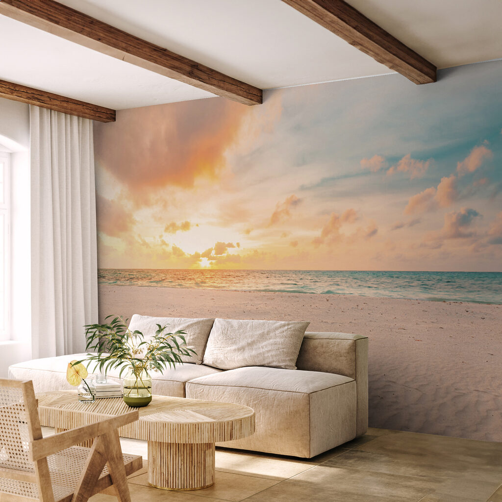 A sandy beach with waves and a sunset