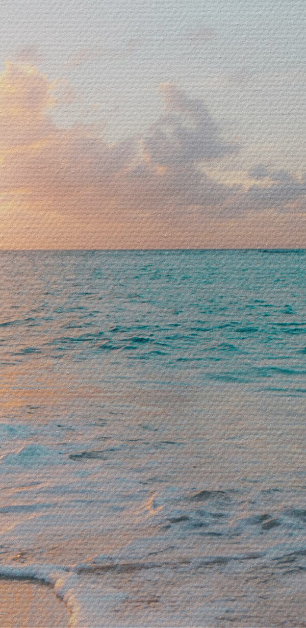 A beach with waves and a sunset