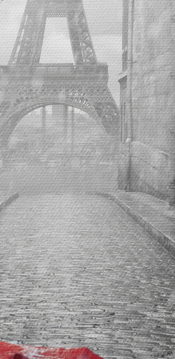 A red umbrella in a street with a tower in the background