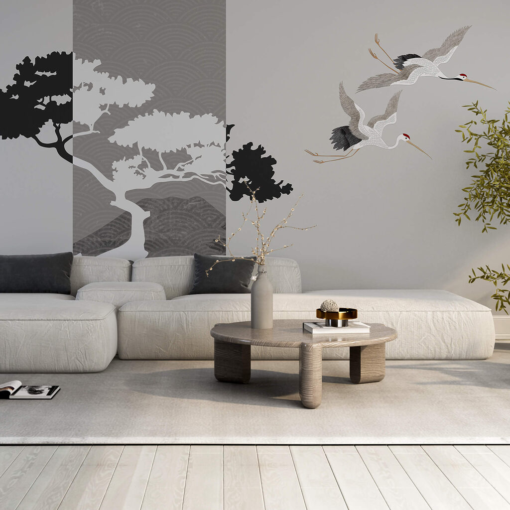 Coppia di gru in volo accanto a un albero