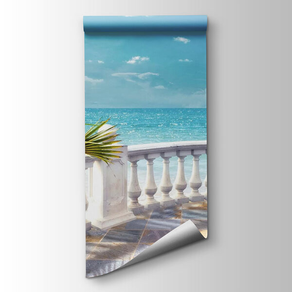 Balcony with a palm tree and a sailboat in the water