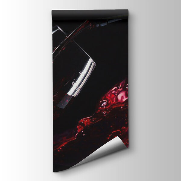 Glass of red wine being poured