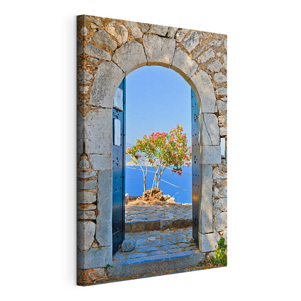 A stone arch with a tree in the background