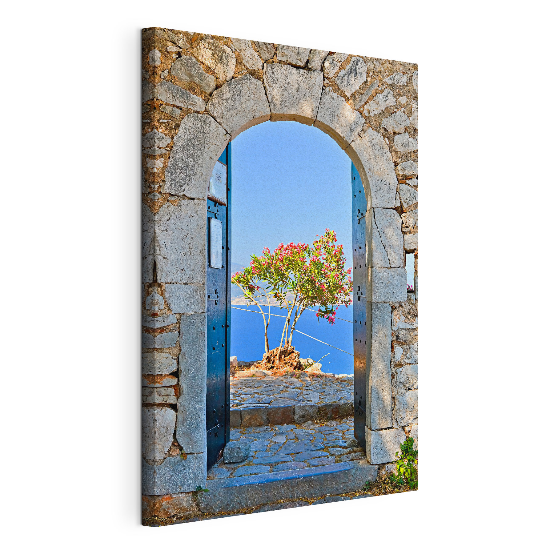 A stone arch with a tree in the background