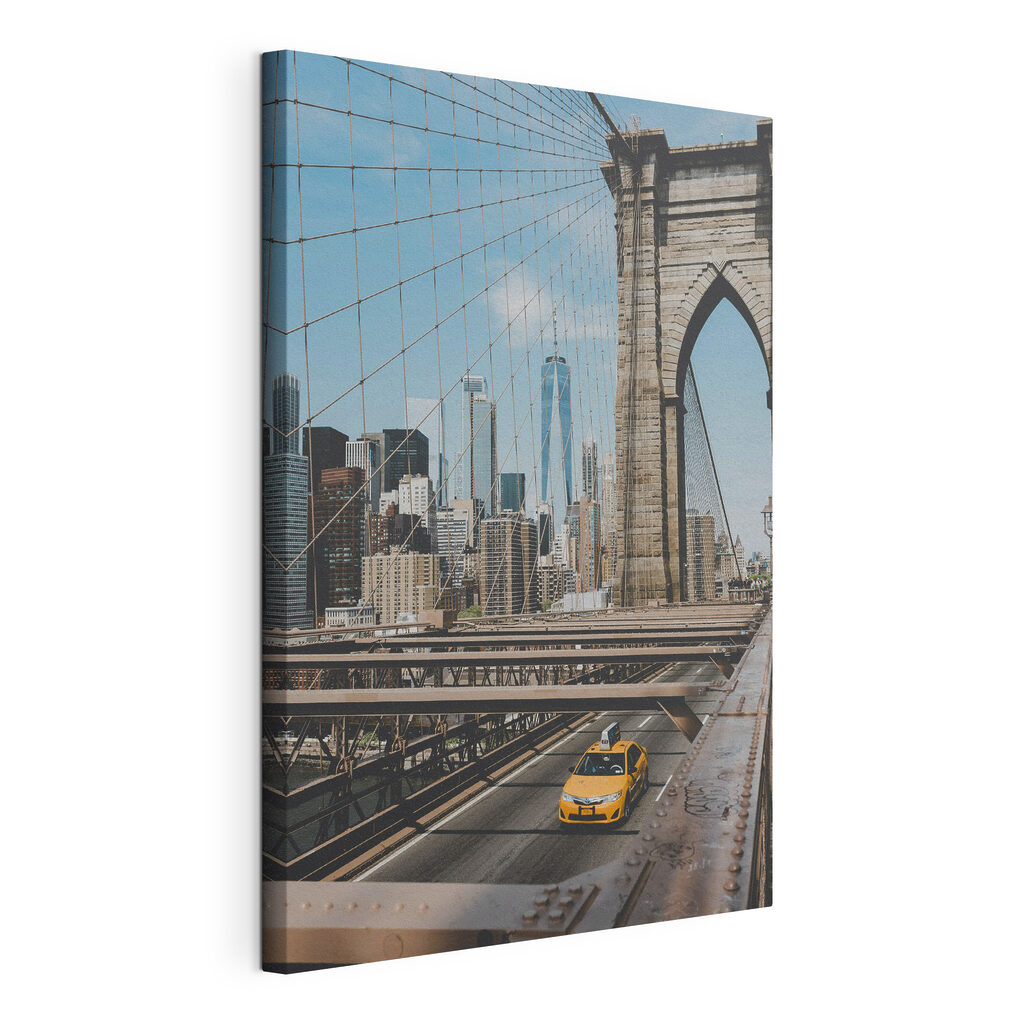 Brooklyn Bridge with a yellow taxi driving down it