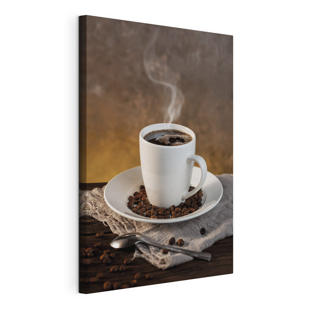 A cup of coffee on a plate with beans and a spoon A cup of coffee on a plate with beans and a spoon