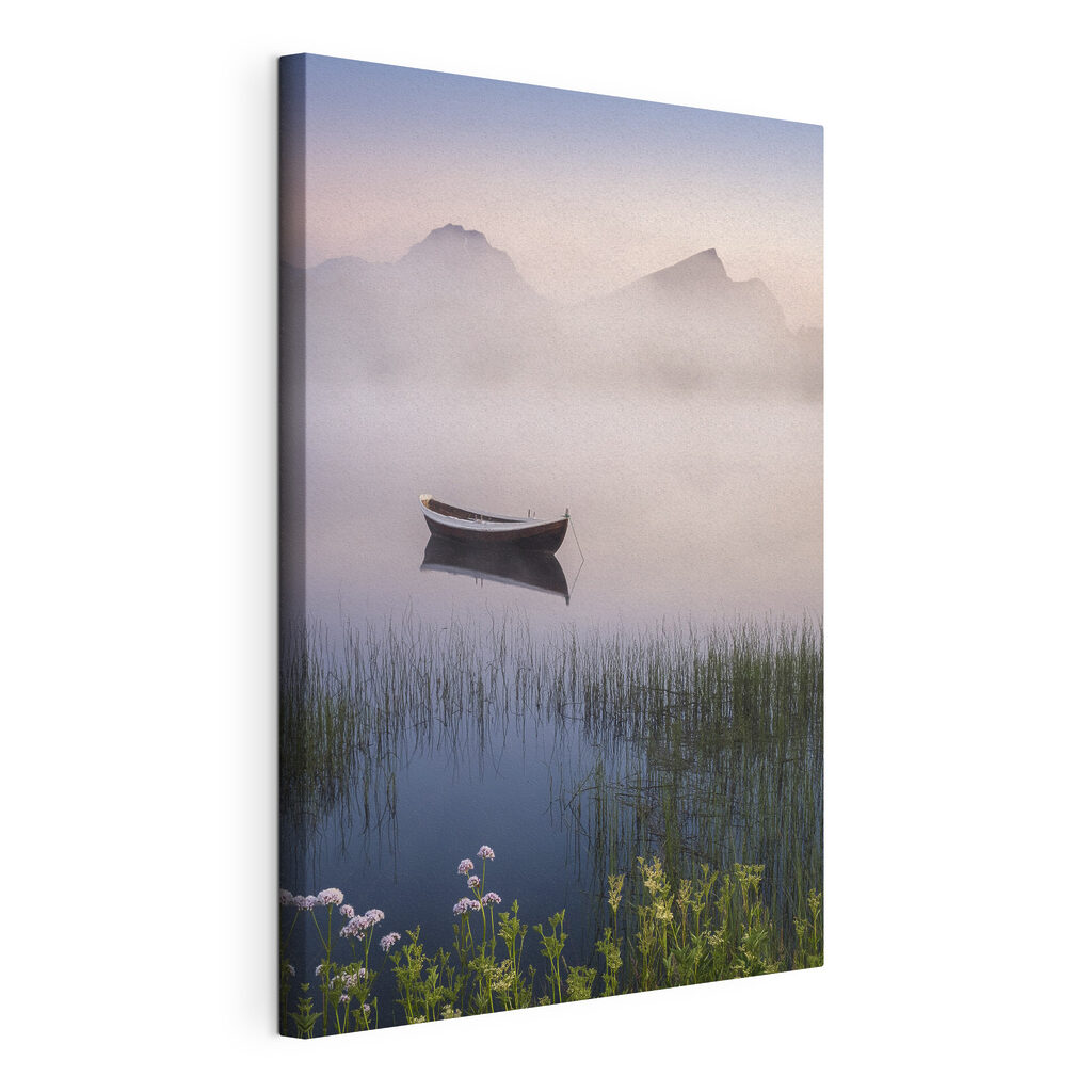 A boat in a lake with grass and mountains in the background A boat in a lake with grass and mountains in the background