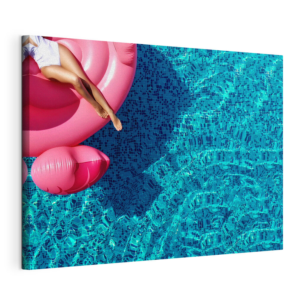 A woman on a pink float in a pool A woman on a pink float in a pool
