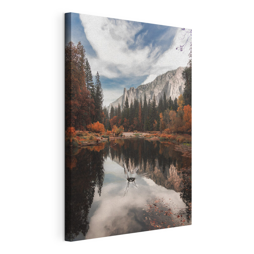 A lake surrounded by trees and mountains