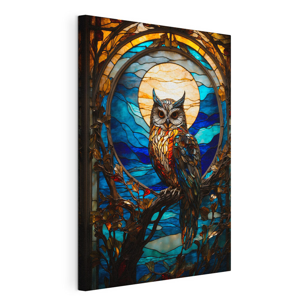 A stained glass owl on a tree branch A stained glass owl on a tree branch