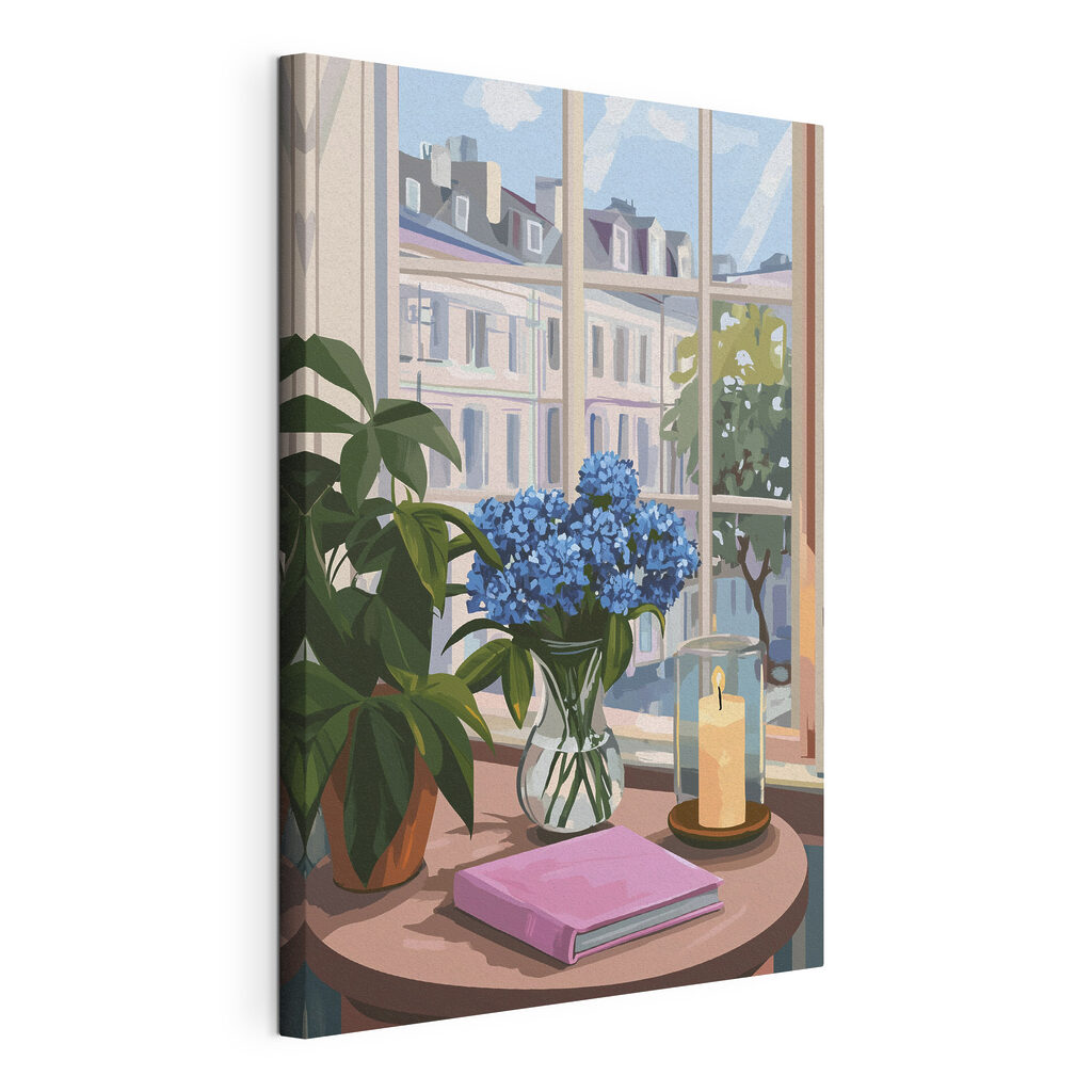 Vase of flowers and a candle in front of a window